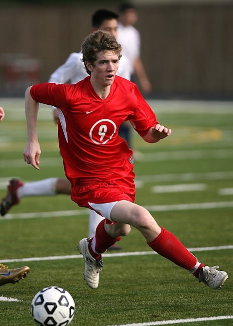 Intense moment during a soccer match with players in action on a grassy field.